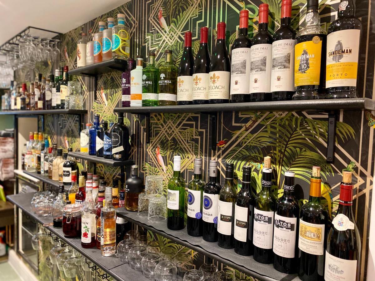 Hotel The Lion At West Pennard Extérieur photo A selection of wine and spirits at the bar